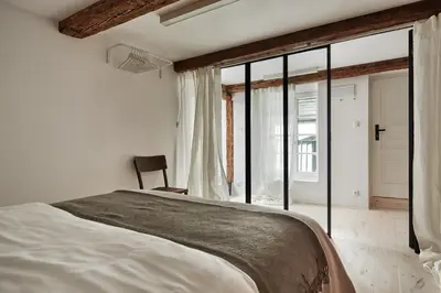 a bedroom with a large bed and a window at OLD NEW - Prime Location on Main Square in Kraków