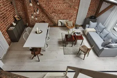 a living room with a couch and a table at OLD NEW - Prime Location on Main Square in Kraków