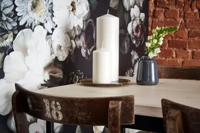 a table with two white candles on top of it at OLD NEW - Prime Location on Main Square in Kraków