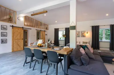 a living room with a table and a couch at Staymoovers - Secret Loft w pobliżu Krakowa in Paszkówka