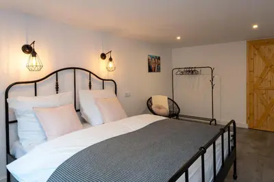a bedroom with a large bed with white pillows at Staymoovers - Secret Loft w pobliżu Krakowa in Paszkówka