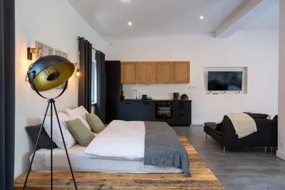 a bedroom with a bed and a lamp in it at Staymoovers - Secret Loft w pobliżu Krakowa in Paszkówka