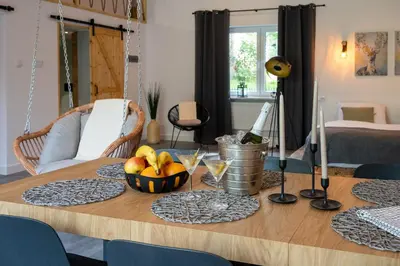 a wooden table with a bowl of fruit on it at Staymoovers - Secret Loft w pobliżu Krakowa in Paszkówka