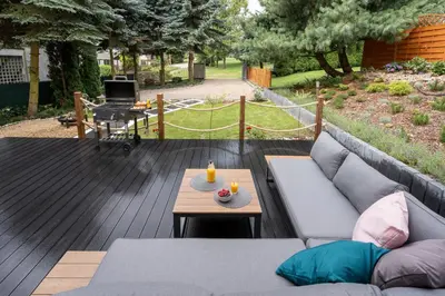 a patio with a couch and a table on a deck at Staymoovers - Secret Loft w pobliżu Krakowa in Paszkówka