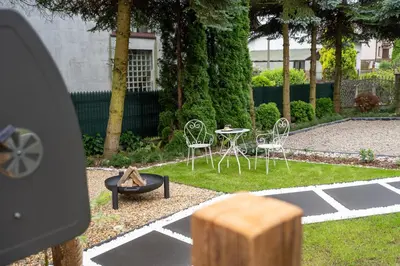 a backyard with a table and chairs and a table and chairs at Staymoovers - Secret Loft w pobliżu Krakowa in Paszkówka