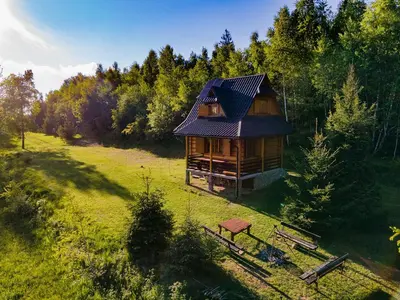 an overhead view of a log cabin in a field at Gorczańska Ostoja in Klikuszowa