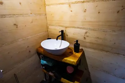 a bathroom with a sink on a wooden table at Gorczańska Ostoja in Klikuszowa