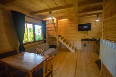 a living room with a table and a couch at Gorczańska Ostoja in Klikuszowa