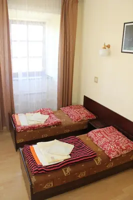 three beds sitting in a room with a window at Dom Pielgrzyma in Kalwaria Zebrzydowska