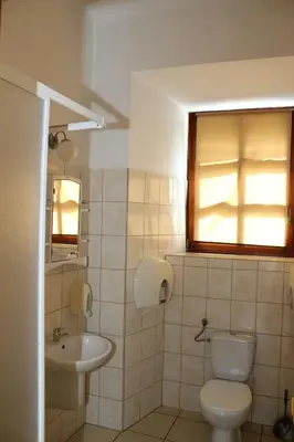 a bathroom with a toilet and a sink at Dom Pielgrzyma in Kalwaria Zebrzydowska