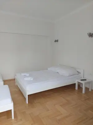 a white bedroom with a bed and a white chair at Noclegi Bachowice - Zator Energylandia Wadowice in Bachowice