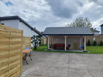 a pavilion with a table and chairs in a yard at Noclegi Bachowice - Zator Energylandia Wadowice in Bachowice