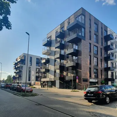 a building on a street with cars parked in front of it at Apartament Green Diamond Rakowicka in Kraków