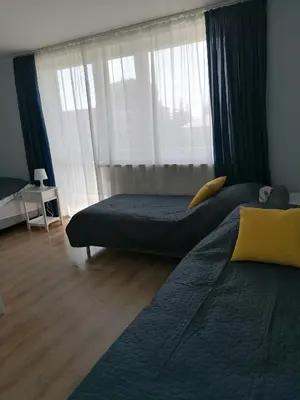 a bedroom with two beds and a window at Gladiator Noclegi Zator lll in Zator