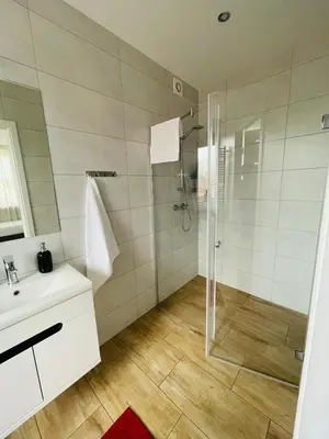 a bathroom with a shower and a sink at Gladiator Noclegi Zator lll in Zator