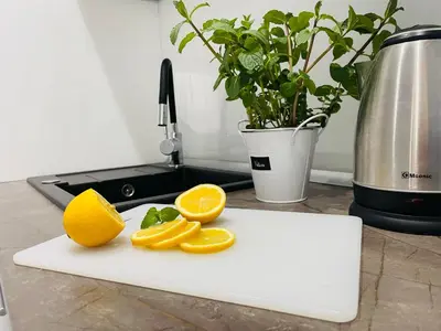 a cutting board with orange slices on it at Gladiator Noclegi Zator lll in Zator