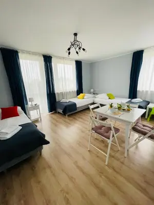 a living room with a bed and a table at Gladiator Noclegi Zator lll in Zator