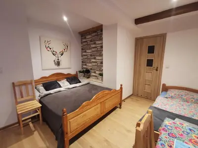 a bedroom with two beds and a brick wall at NOCLEGI POD STODOŁĄ in Kraków
