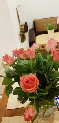 a vase of pink roses sitting on a table at NOCLEGI POD STODOŁĄ in Kraków