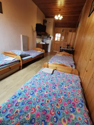 a room with three beds in a room at NOCLEGI POD STODOŁĄ in Kraków