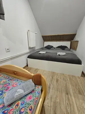 a bedroom with two beds in a room at NOCLEGI POD STODOŁĄ in Kraków