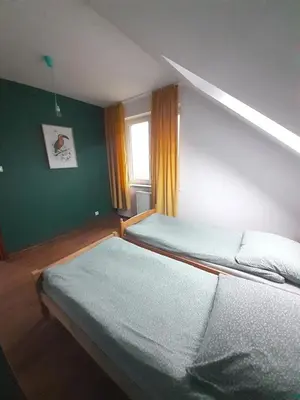 a bedroom with two beds and a window at Dom w okolicach Czchowa in Wytrzyszczka