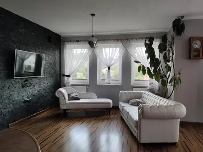 a living room with two white couches and two windows at Dom w okolicach Czchowa in Wytrzyszczka