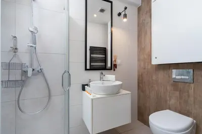 a bedroom with a bed and a desk with a chair at Apartments Dietla Cracow by Noclegi Renters in Kraków