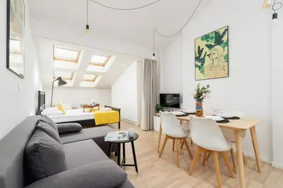 a green couch in a living room with a television at Apartments Dietla Cracow by Noclegi Renters in Kraków
