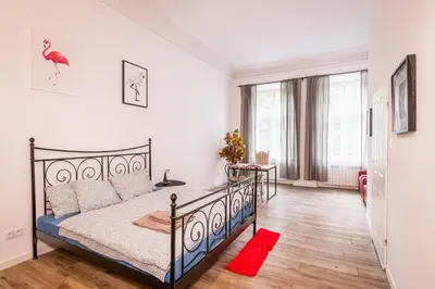 a bedroom with a bed and a large window at Apart 3b in Kraków