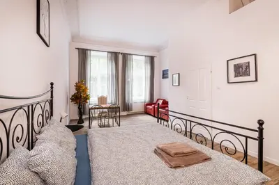 a bedroom with a bed and a living room at Apart 3b in Kraków