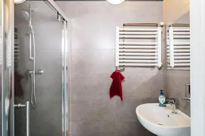 a bathroom with a shower and a sink and a toilet at Apart 3b in Kraków