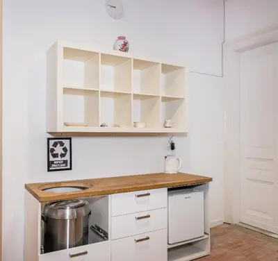 a kitchen with white cabinets and a counter top at Apart 3b in Kraków