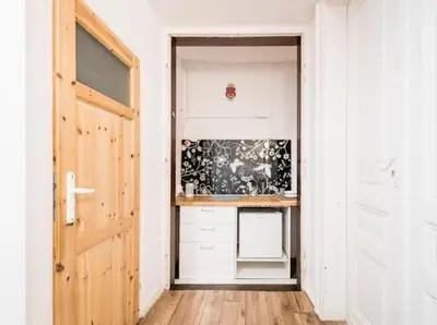 a hallway with a door leading to a kitchen at Apart 3b in Kraków