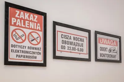 three framed signs hanging on a wall at Apart 3b in Kraków