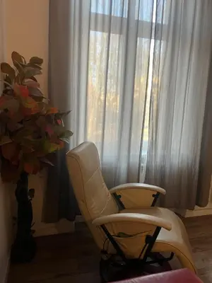 a white chair sitting in front of a window at Apart 3b in Kraków