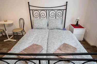 a bedroom with a bed with a metal frame and a table at Krakus in Kraków