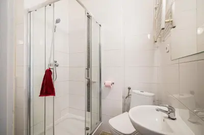 a bathroom with a shower and a toilet and a sink at Krakus in Kraków