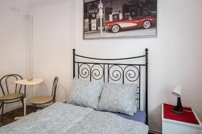 a bedroom with a bed and a red car on the wall at Krakus in Kraków