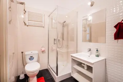 a bathroom with a shower and a toilet and a sink at Laykonik in Kraków