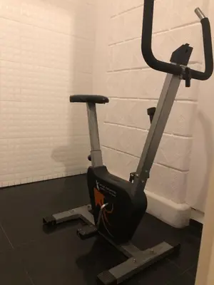 a exercise bike in a room with a wall at Laykonik in Kraków