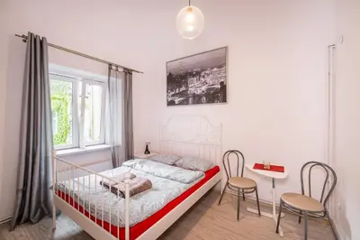 a bedroom with a bed and a table and chairs at Laykonik in Kraków