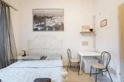 a bedroom with a bed and a table and chairs at Laykonik in Kraków