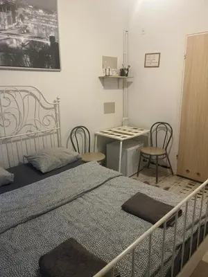 a bedroom with a bed and a table and chairs at Laykonik in Kraków