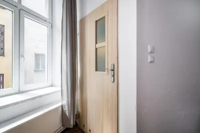 an open door in a room with a window at LoL in Kraków