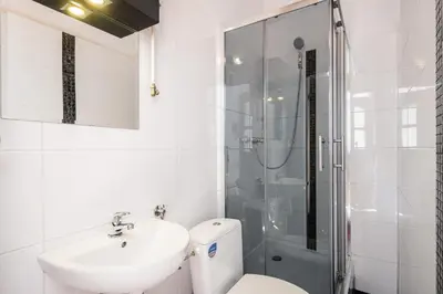 a bathroom with a toilet and a sink and a shower at LoL in Kraków