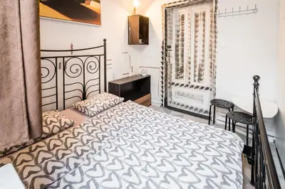 a bedroom with a bed and a desk and a window at KRAKOWIAK in Kraków