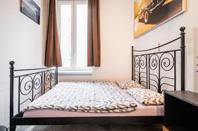 a small bed in a room with a window at KRAKOWIAK in Kraków