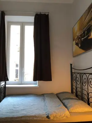 a bedroom with a bed and a window at KRAKOWIAK in Kraków