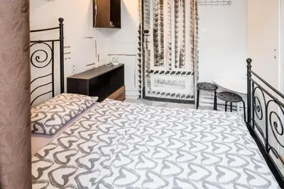 a bedroom with a bed and a table at KRAKOWIAK in Kraków